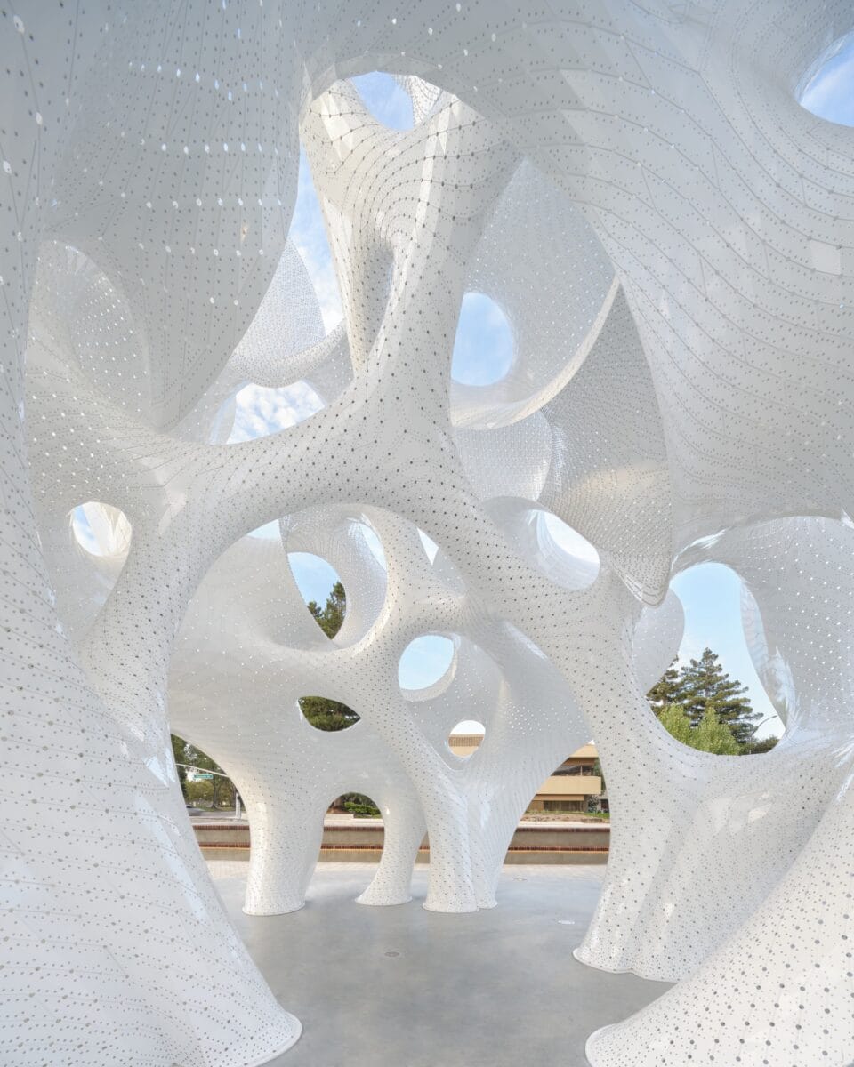 a detail of the interior of a contemporary white architectural pavilion with undulating forms in the overall shape of a sphere
